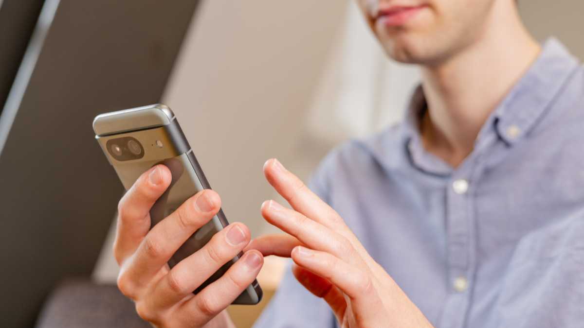 A man using the Google Pixel 8 smartphone