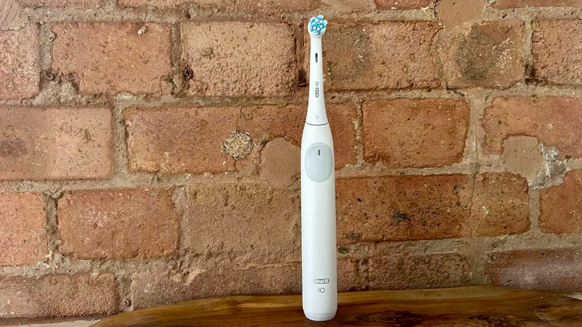 Oral-B iO2 standing against a brick wall