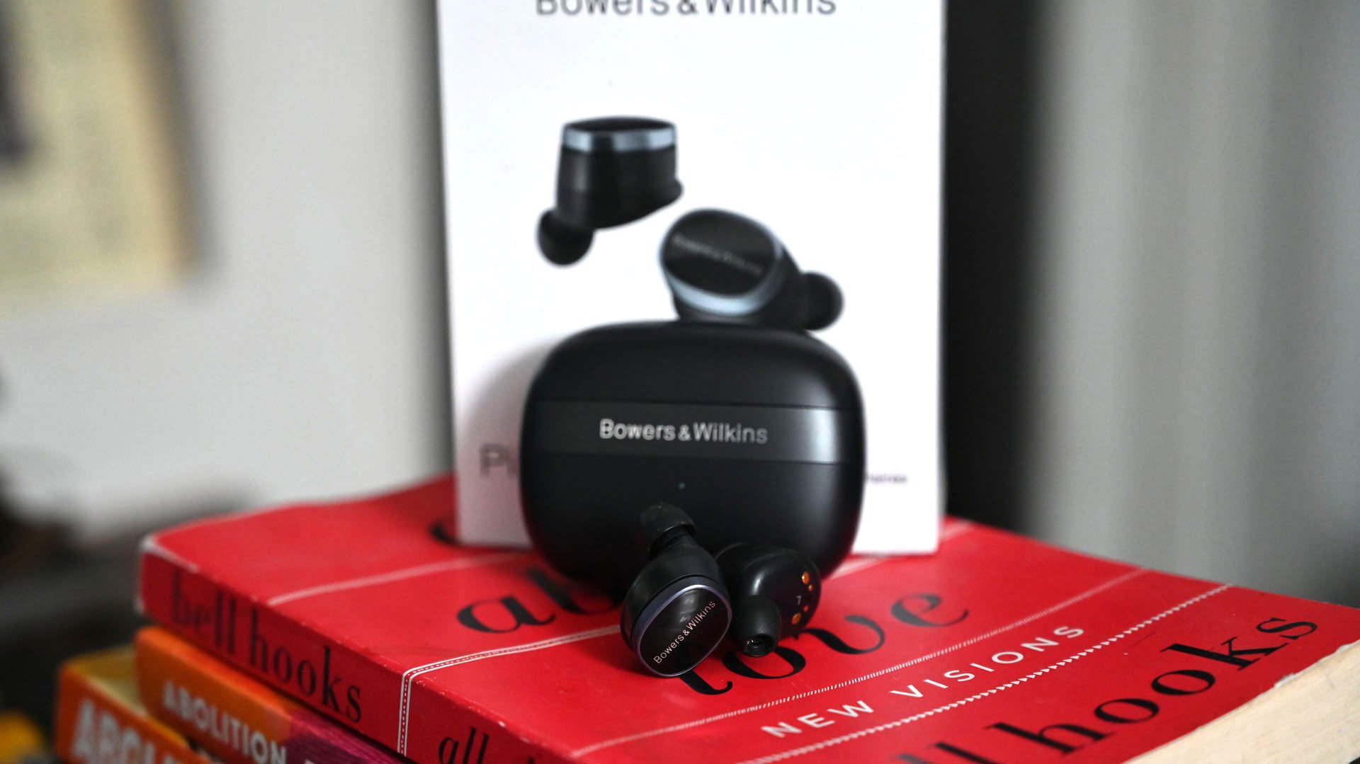 Shot of Bowers & Wilkins Pi8 earbuds with charging case and box