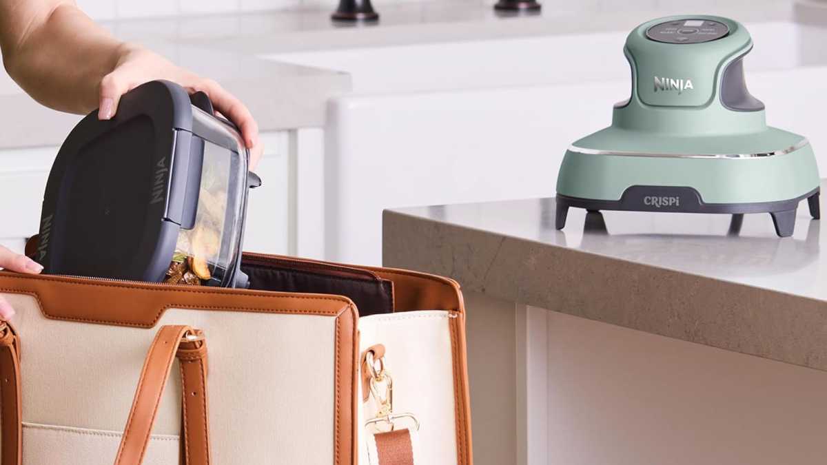 A hand putting the glass Crispi container into a bag