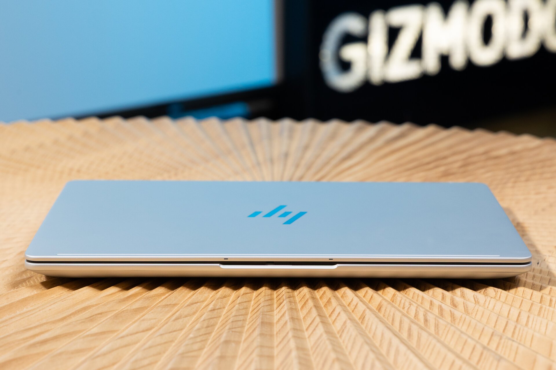 Front shot of HP EliteBook X G1a resting on wooden table with Gizmodo sign in the background