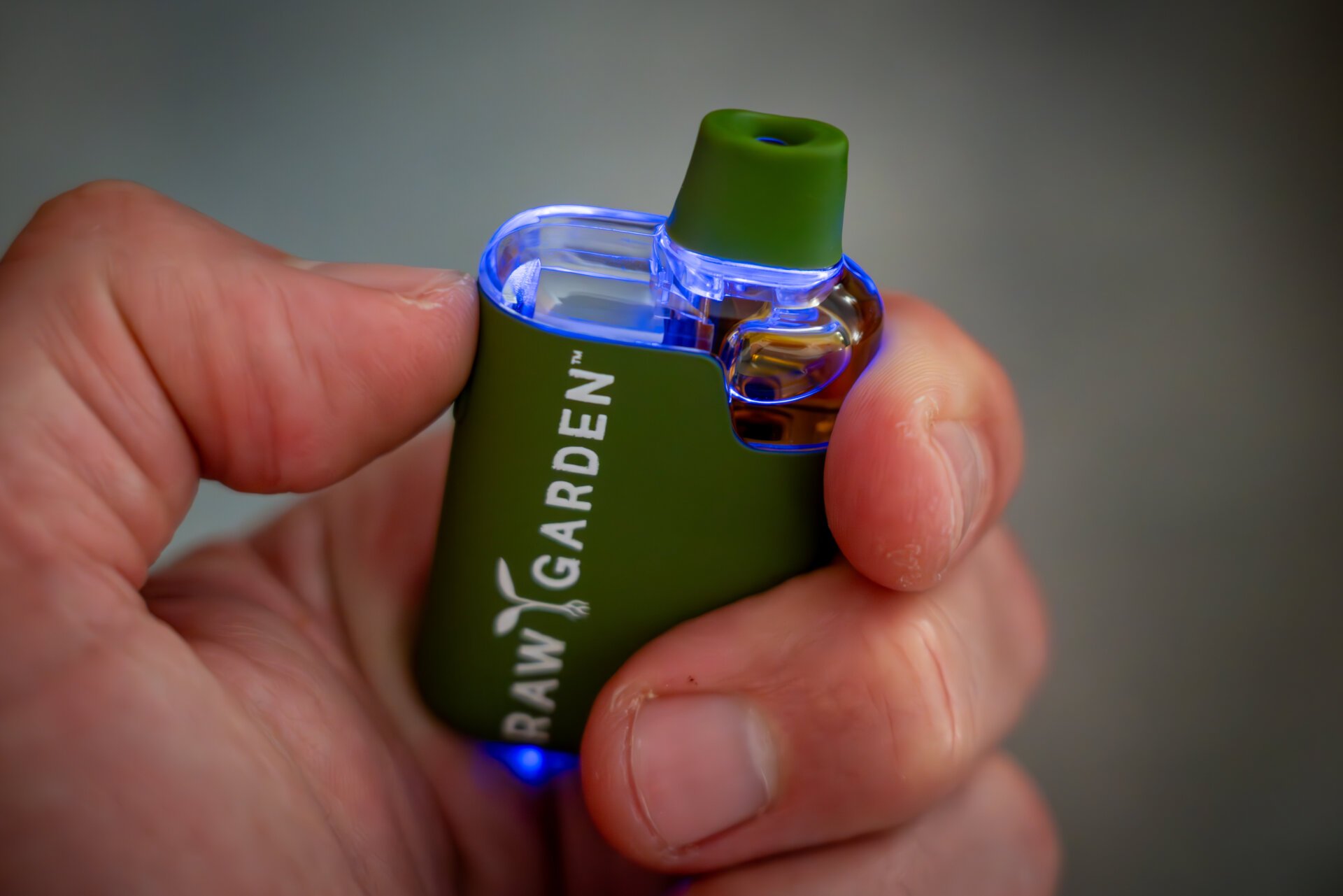 An image of the vape turned on, all clear components glow blue.