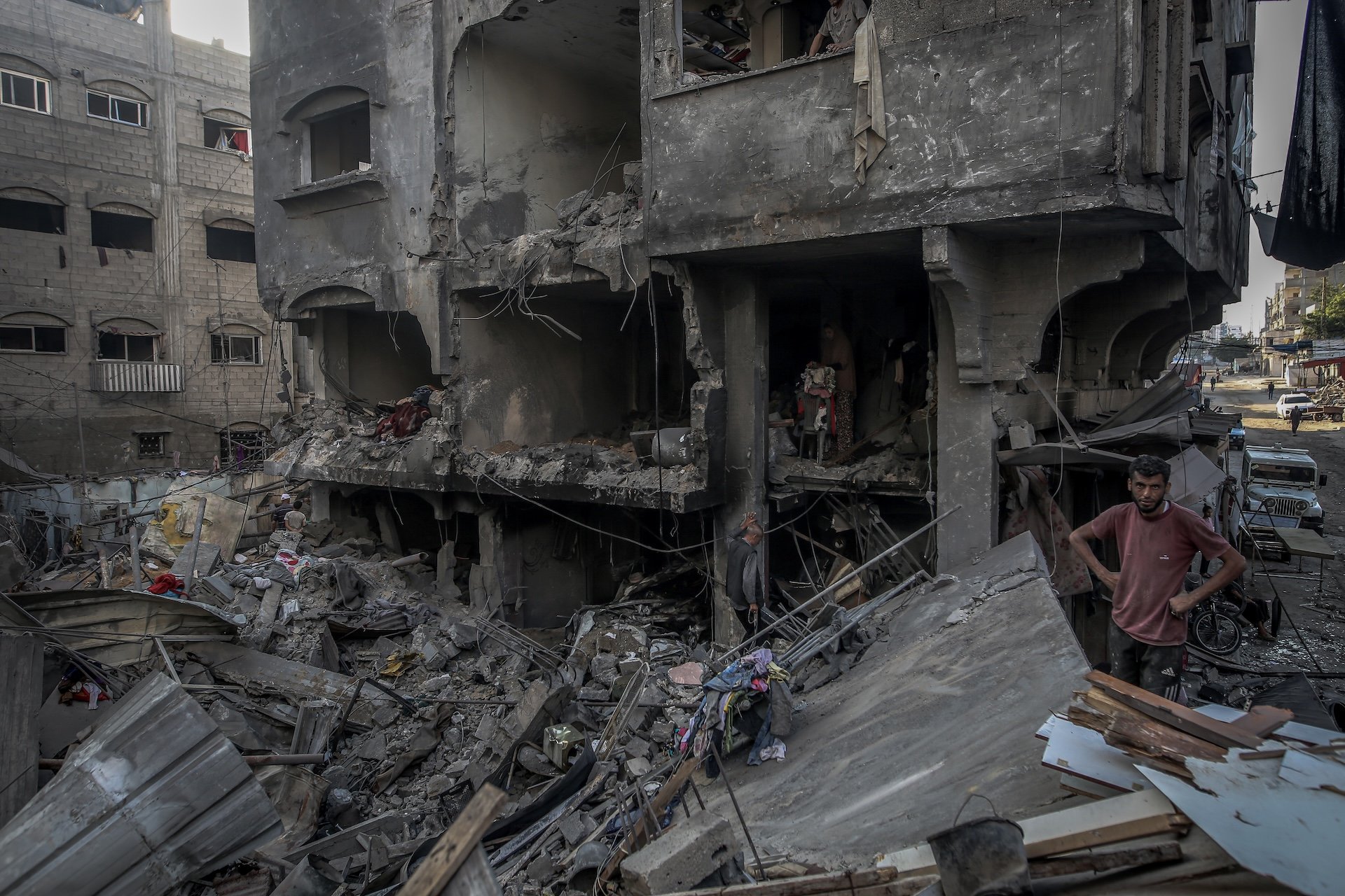 Palestinians search for usable items in the rubble of heavily damaged and collapsed buildings after Israeli attacks on Al-Shati refugee camp in Gaza City, Gaza on June 26, 2025.