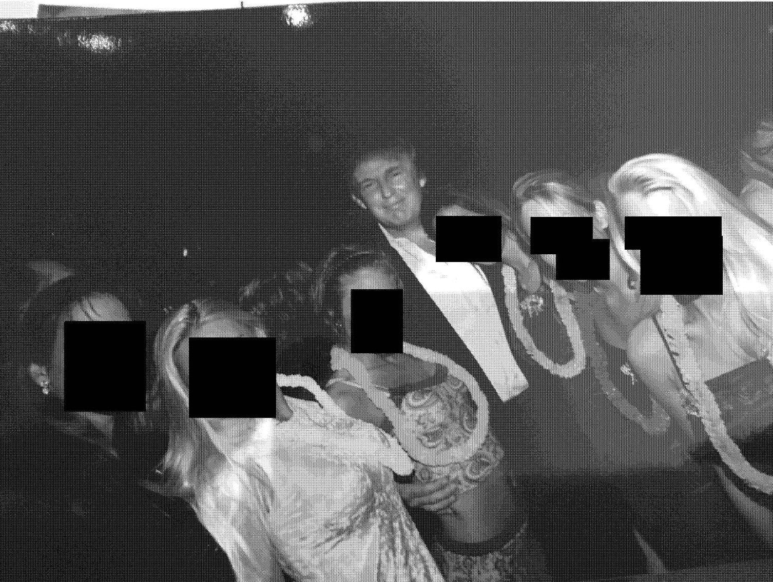 President Donald Trump in an undated photo with several people whose faces have been redacted.