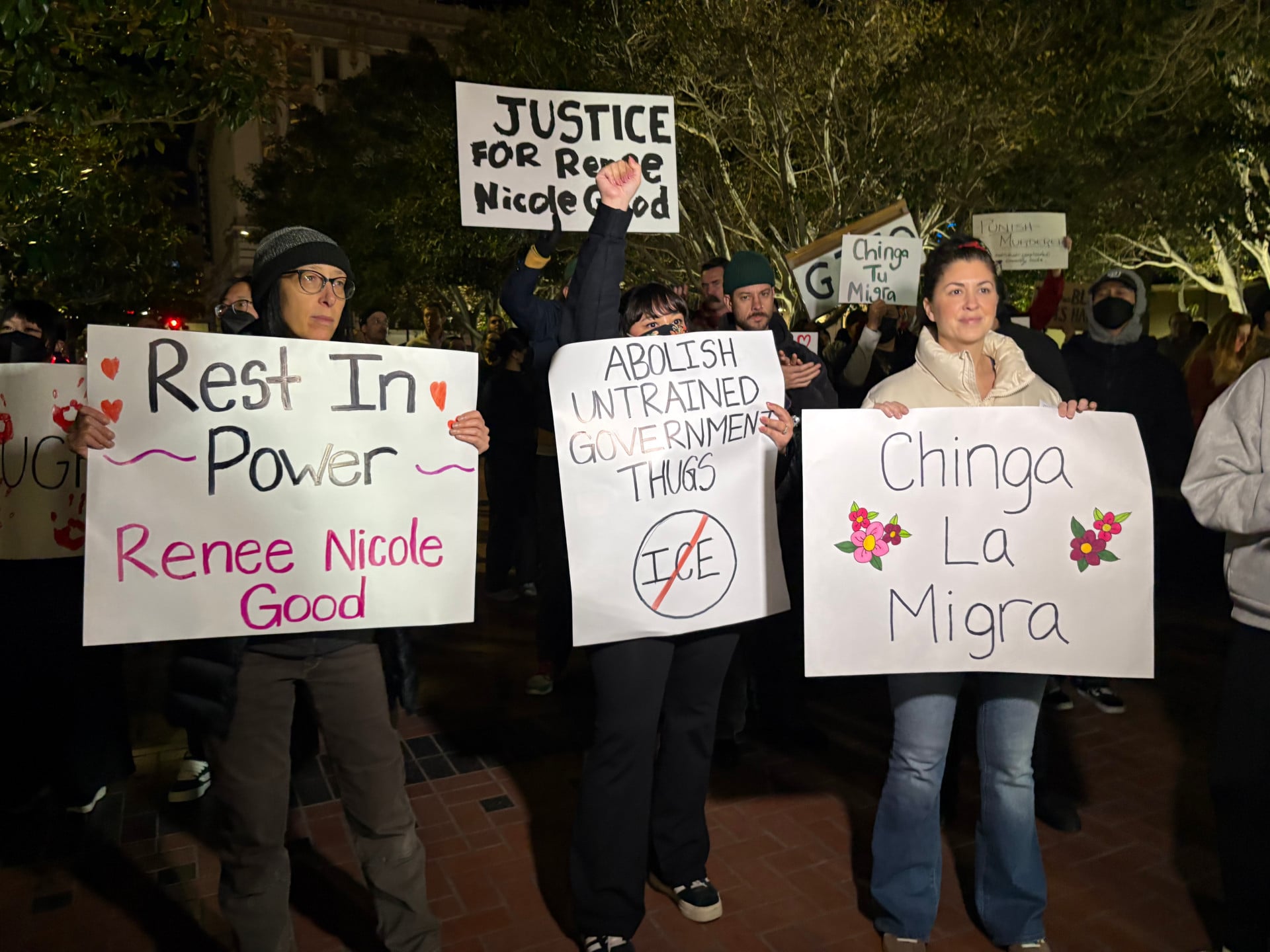 Protesters hold signs calling for justice for Renee Good in downtown San Diego, California, on Jan. 8, 2026.