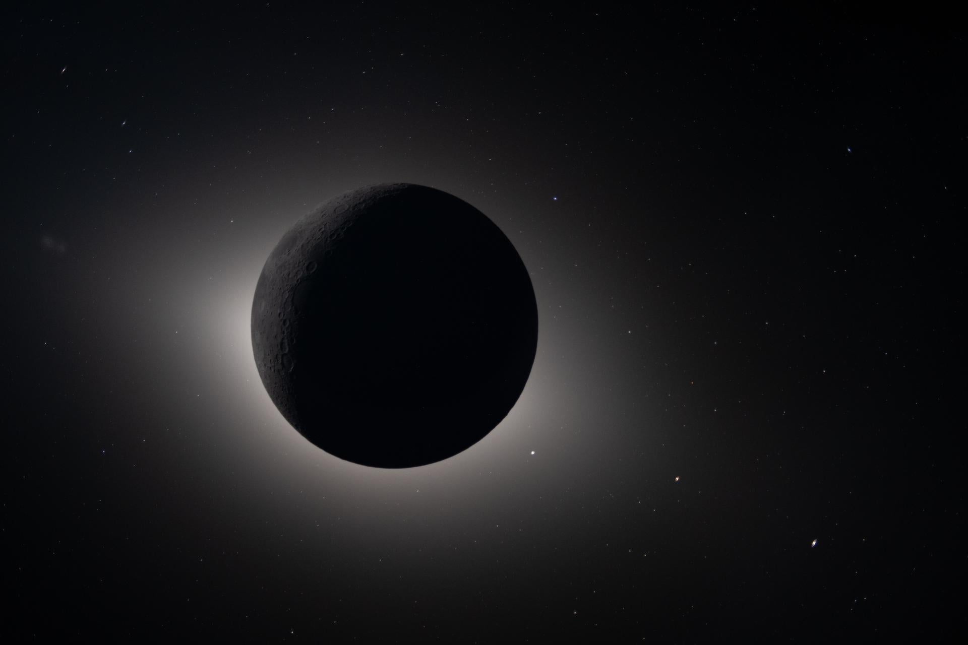 Captured by the Artemis II crew during their lunar flyby on April 6, 2026, this image shows the Moon fully eclipsing the Sun