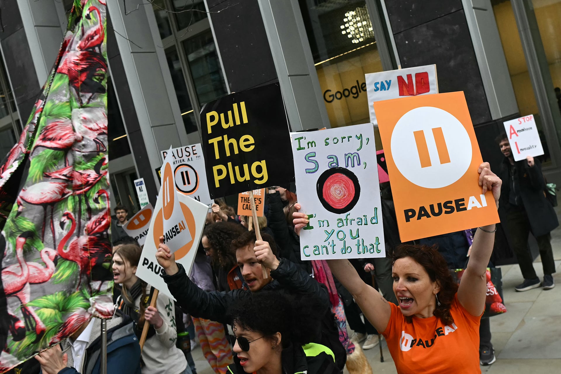Protesters gather with banners and placards outside the offices of Google Deepmind at a protest organized by PauseAI UK and other groups concerned in controlling the development of advanced Artificial Intelligence systems, in London on February 28, 2026.