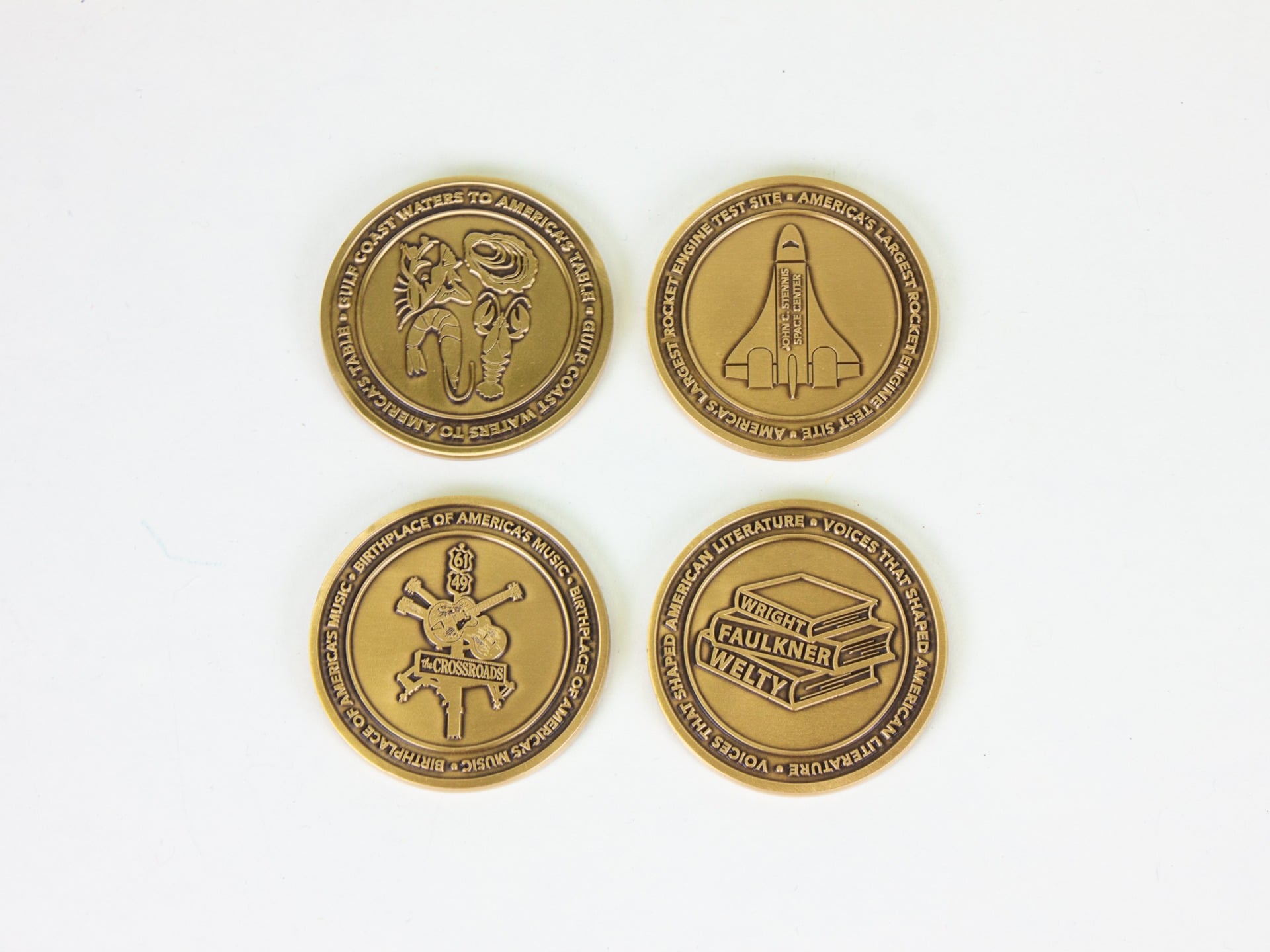 Four brass coins included by the state of Mississippi in the America 250 time capsule, which will be buried on July 4, 2026.