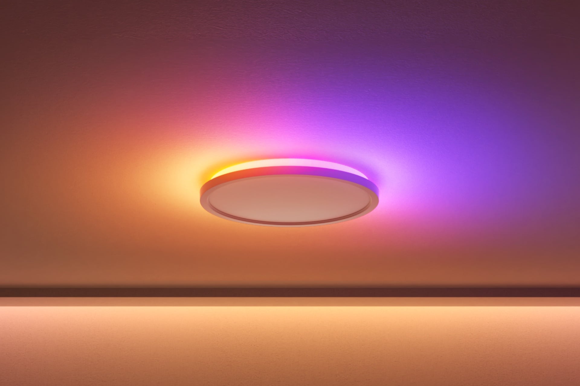 Nanoleaf's Smart Multicolor Ceiling Light with only its top lights on, showing a yellow-to-purple gradient.