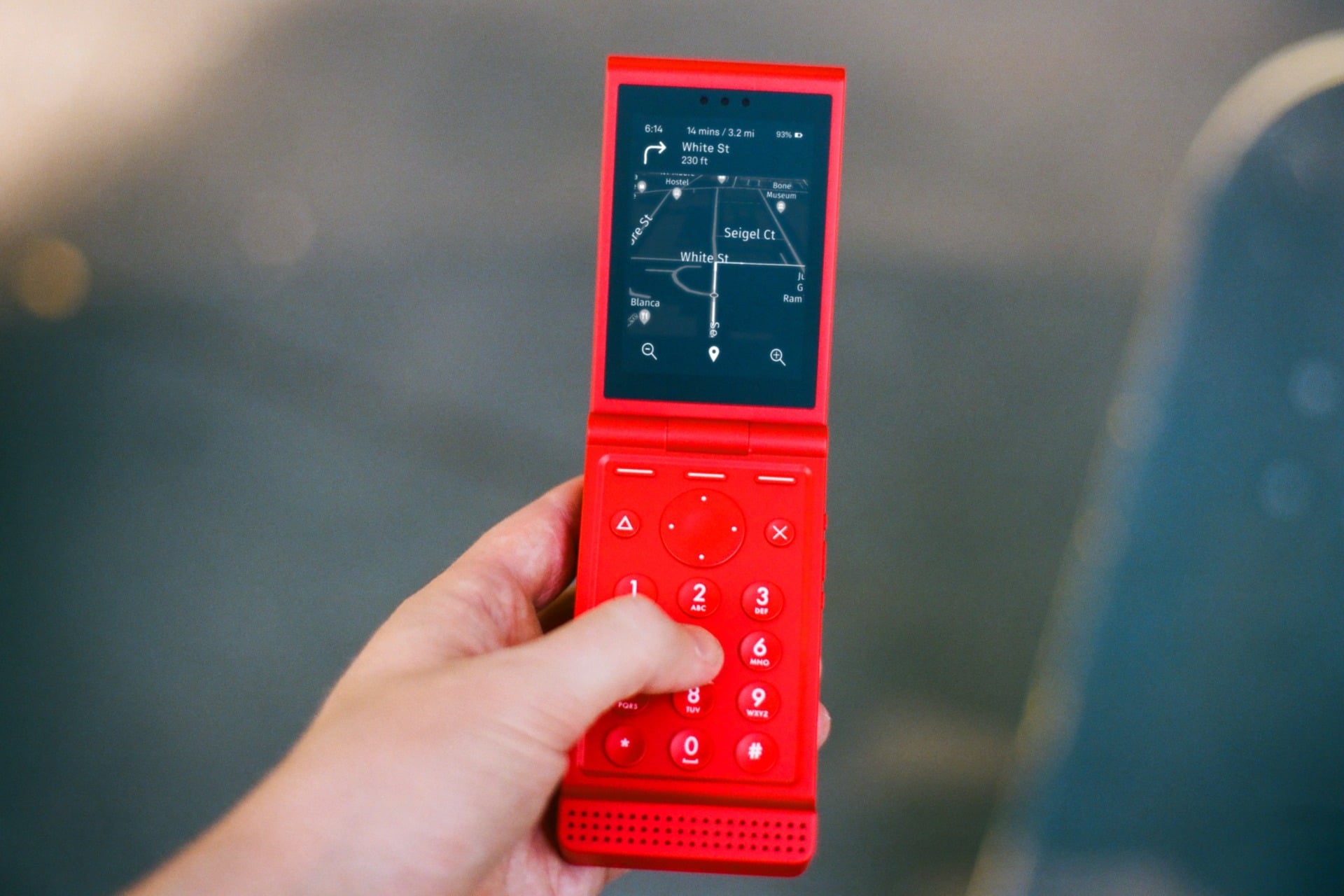 A Light Flip phone in red showing Google maps