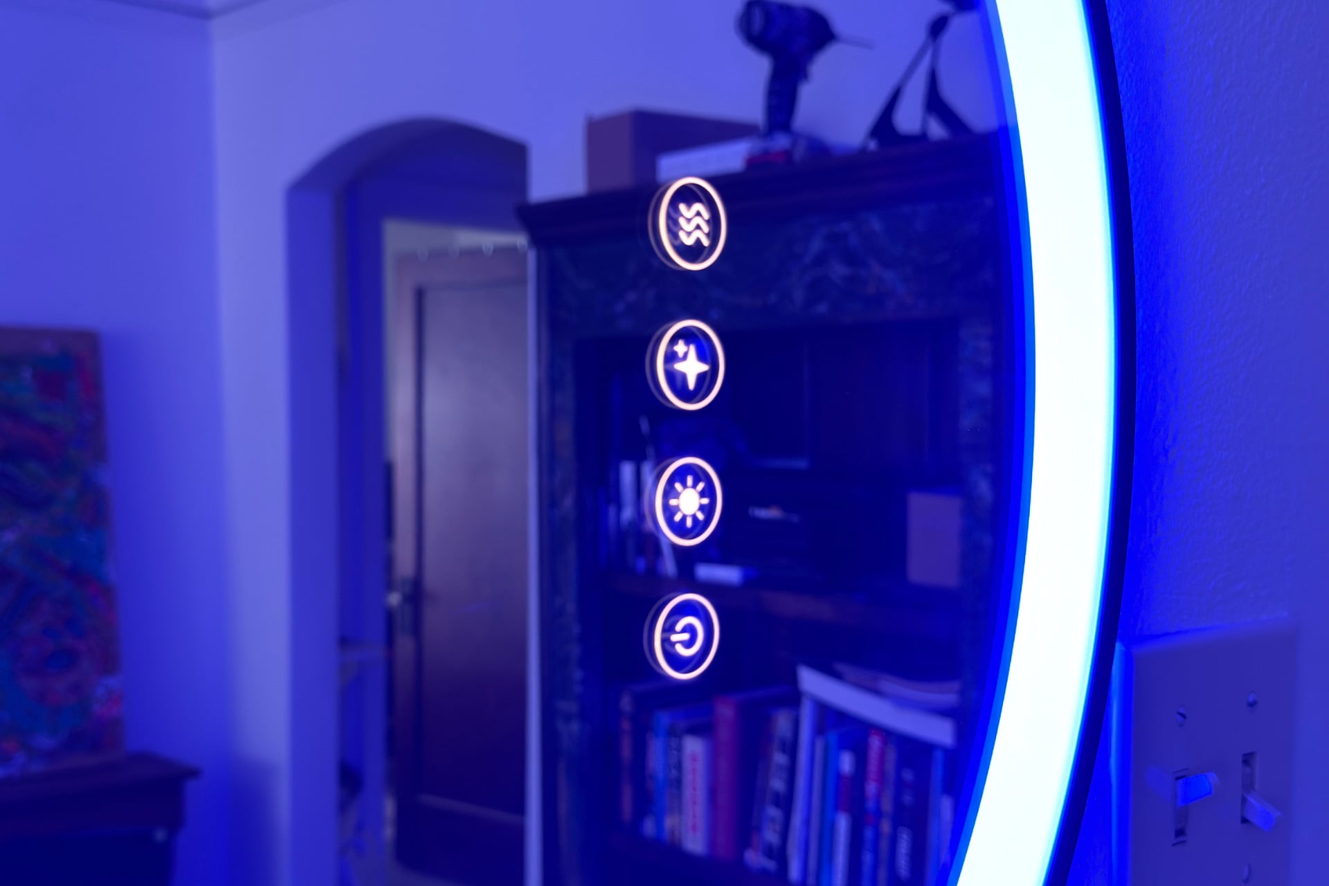 Closeup of the Lifx Smart Mirror's buttons, arranged from top to bottom: defox, makeup check, light temperature, and power.