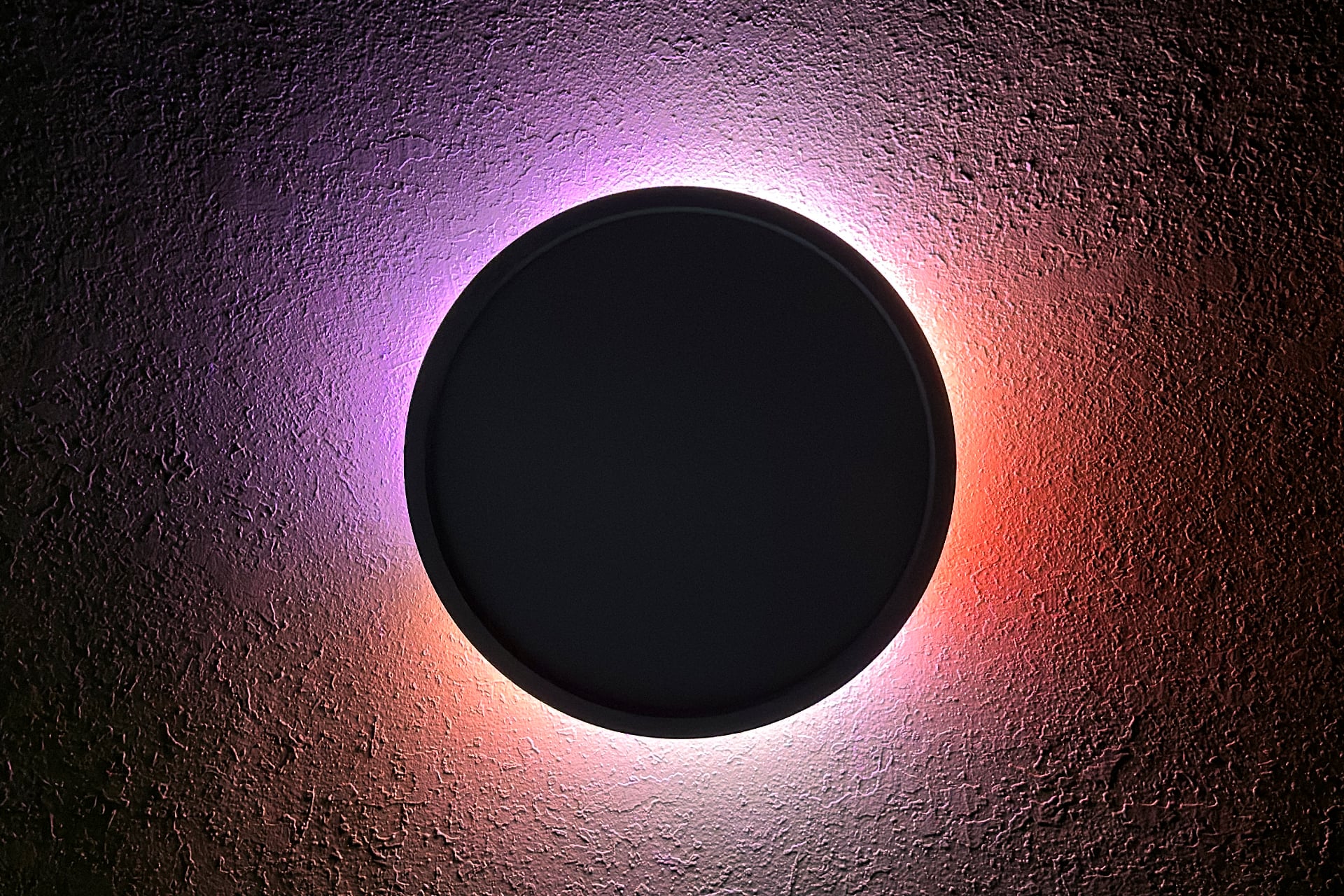 Nanoleaf Smart Multicolor Ceiling Light with only its top light on, showing gradients of pinkish purple, white, and red