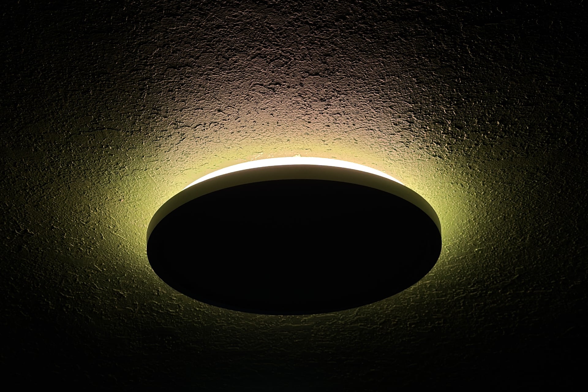 Nanoleaf Smart Multicolor Ceiling Light from the side with only its upper light on