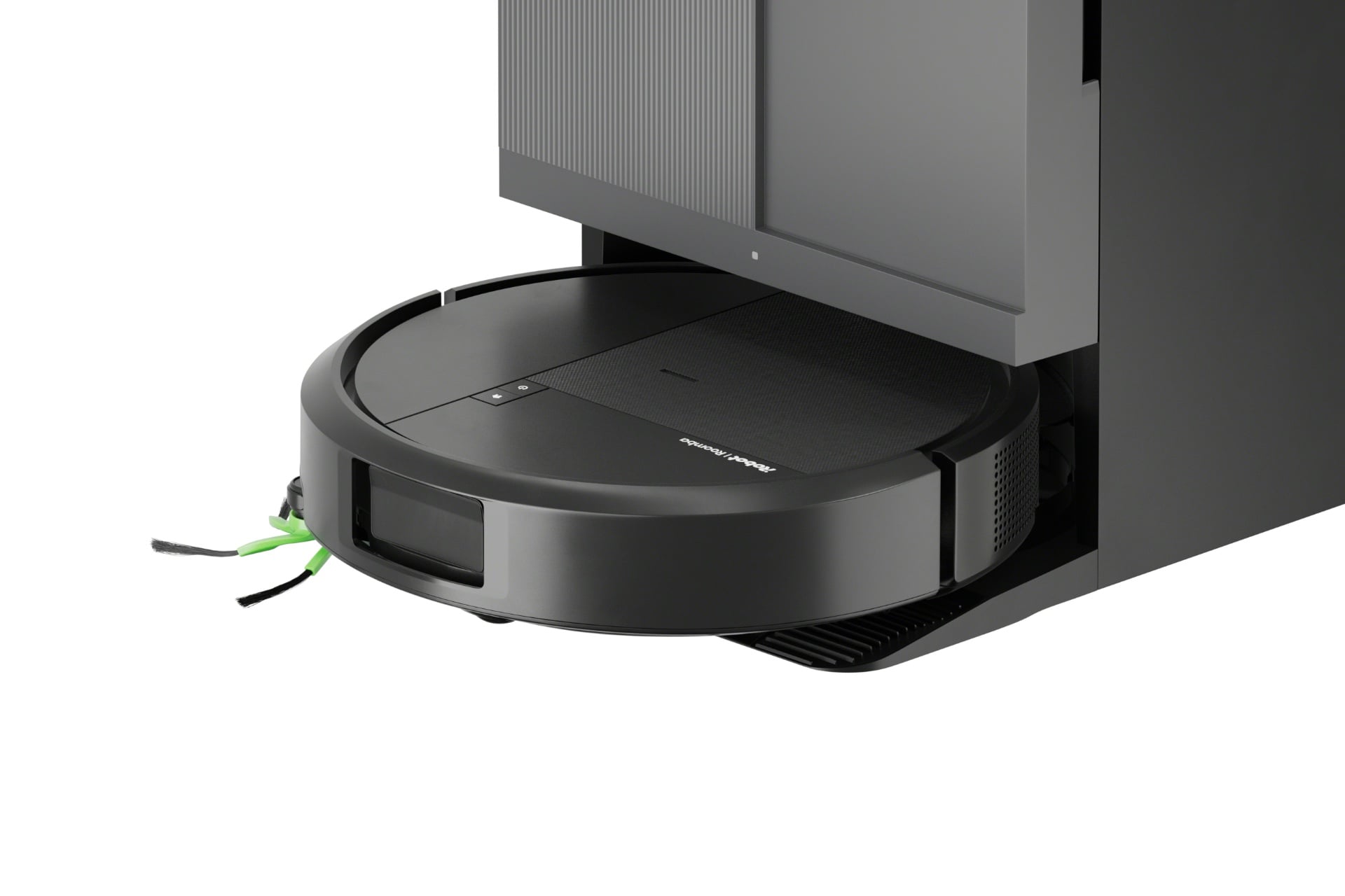 Close-up of the Roomba Plus 415 in its dock. It's black, lacks a sensor disc, and has a visible side brush.