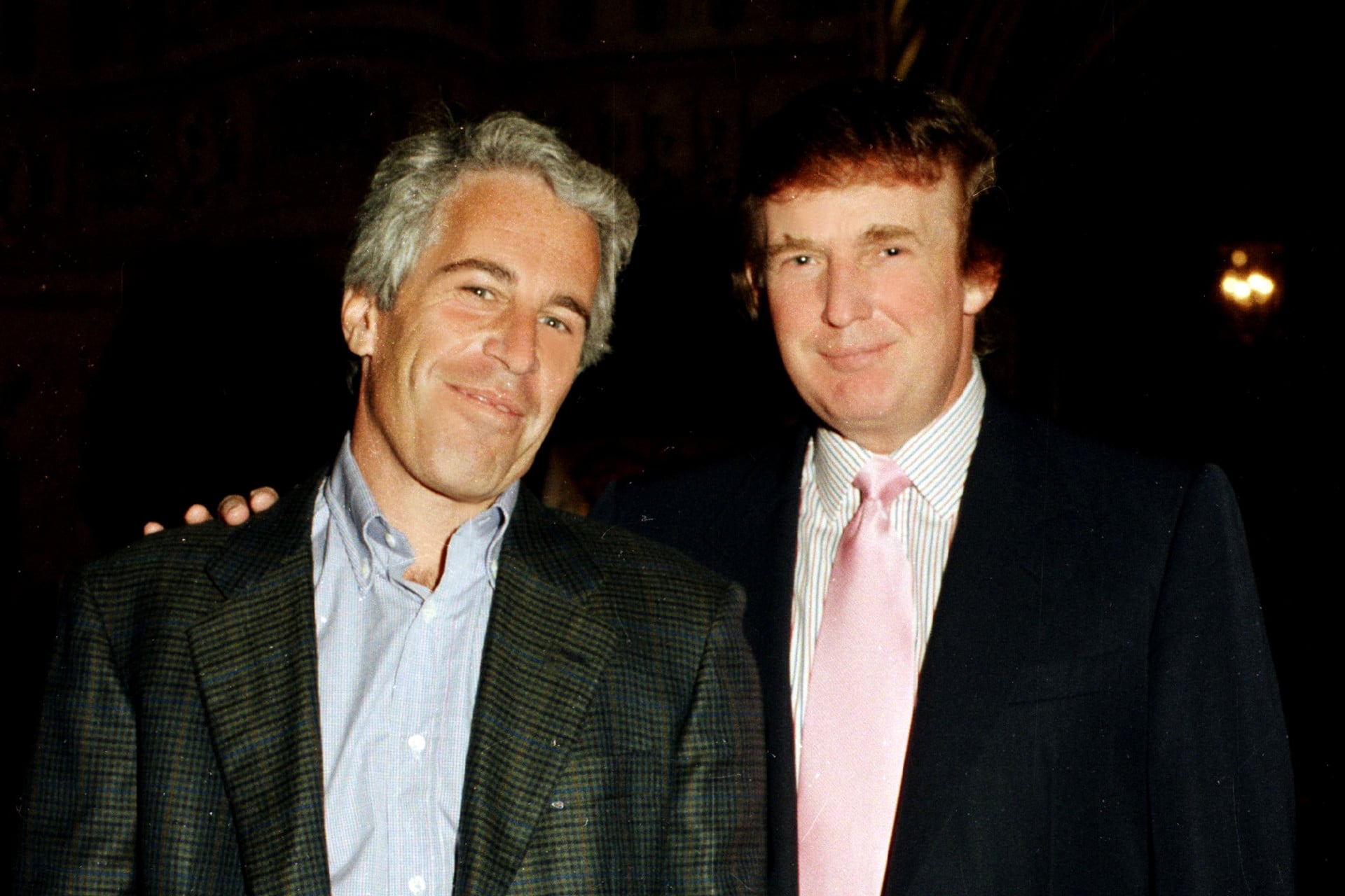 Jeffrey Epstein and Donald Trump pose together at the Mar-a-Lago estate, Palm Beach, Florida, 1997.