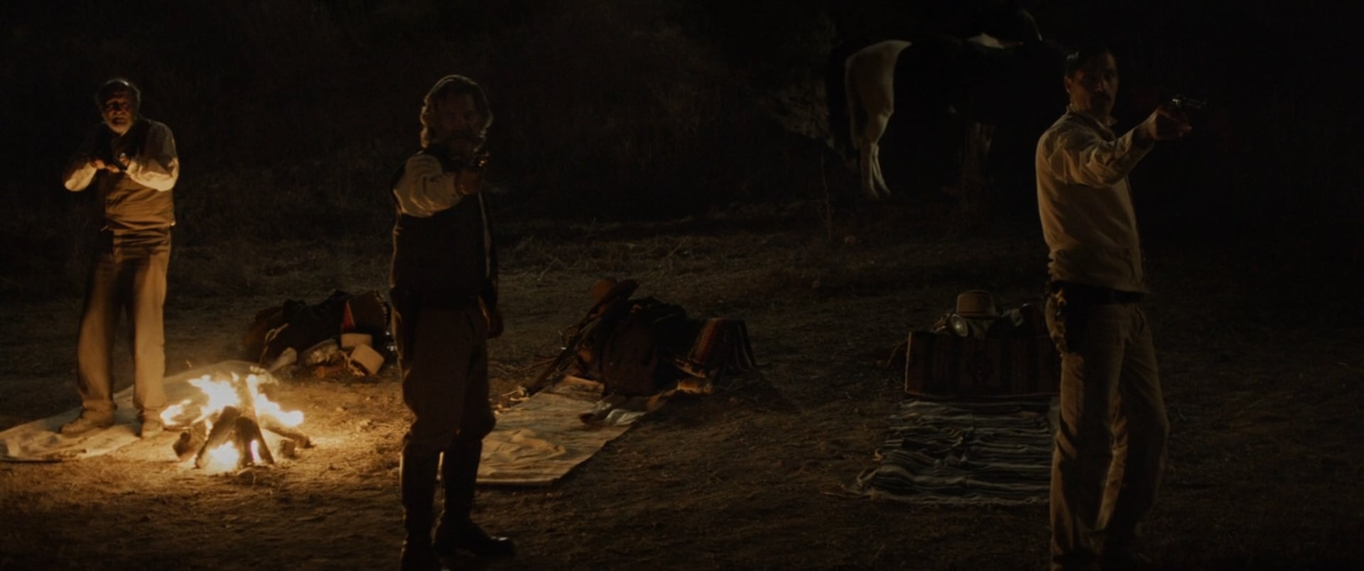 Bone Tomahawk still of cowboys drawing their guns.