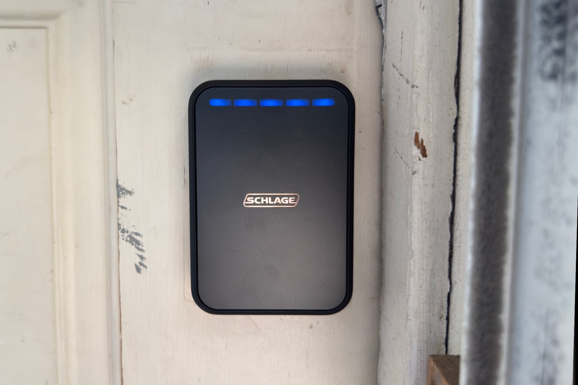 Schlage Sense Pro keypad portion shown with five blue lights along the top row, indicating it has sensed UWB signal from a device and is unlocking.
