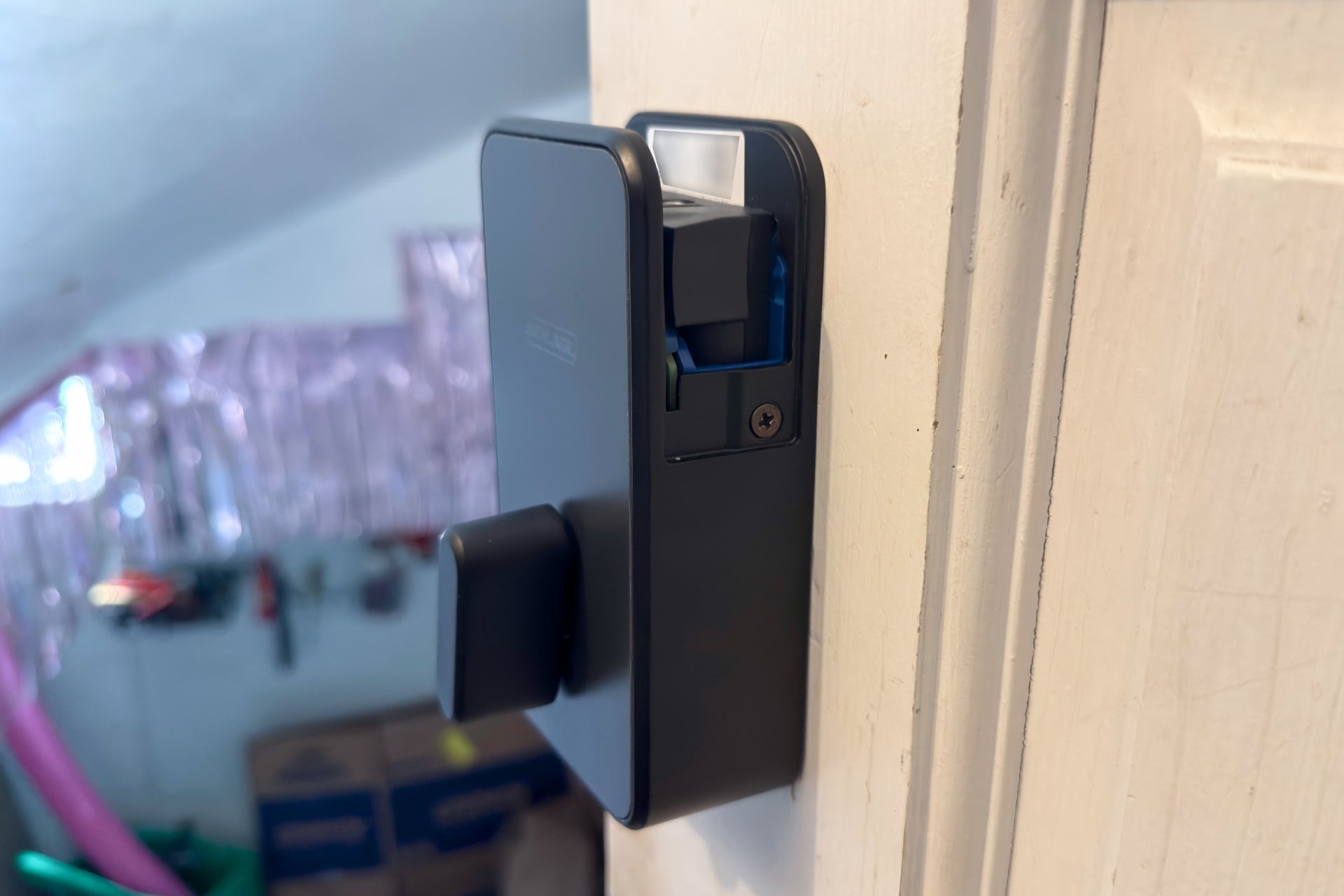 Schlage Sense Pro interior part with battery cover off. It's tall and rectangular, with a large, rounded thumbturn.