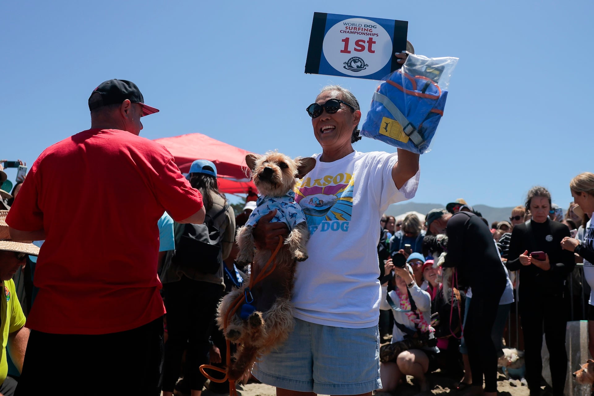 Bradley "Shortboard" Cooper and his owner celebrate at the World Dog Surfing Championships on August 01, 2026 in Pacifica, California. 