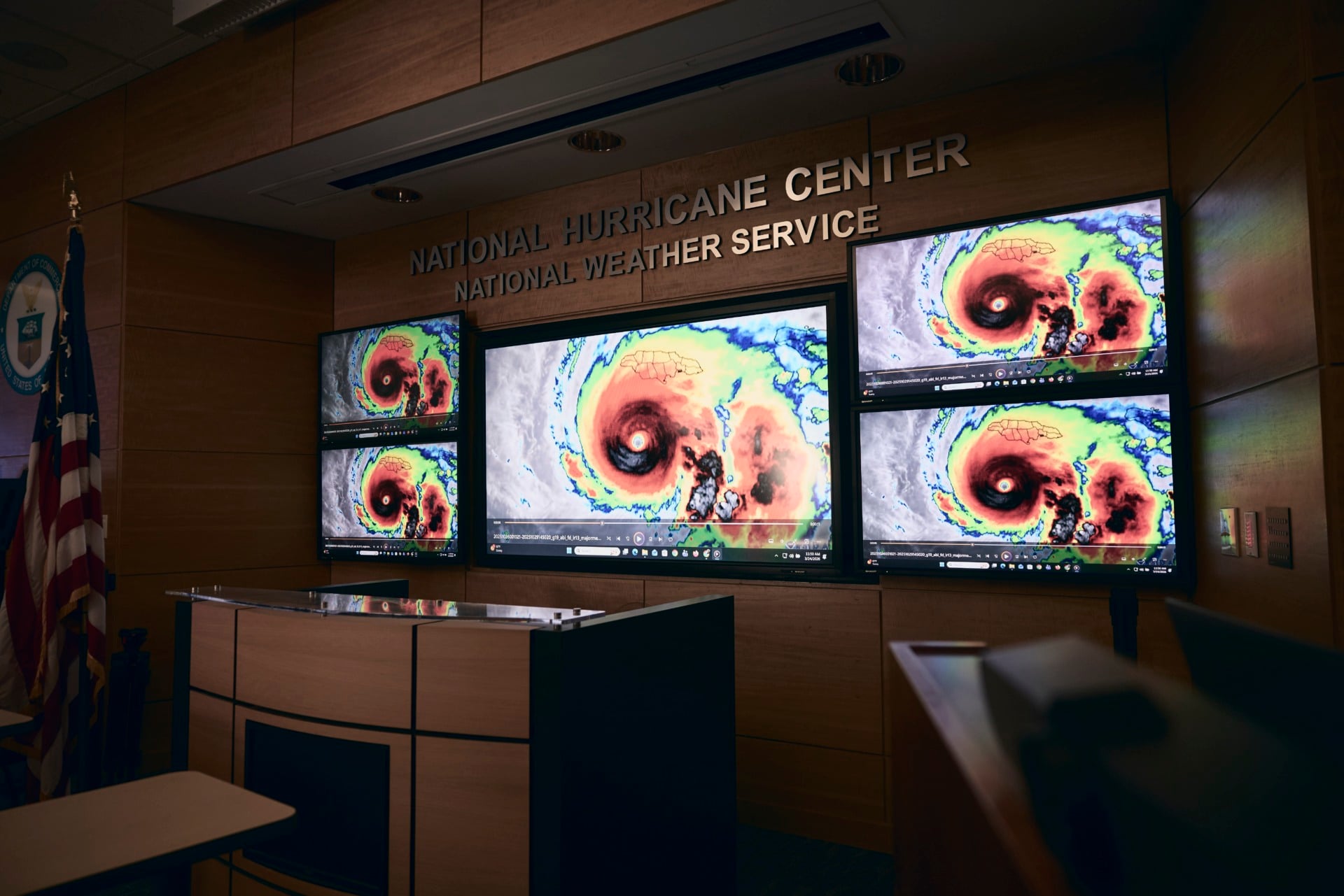 computer screens showing satellite imagery of Hurricane Melissa at the National Hurricane Center