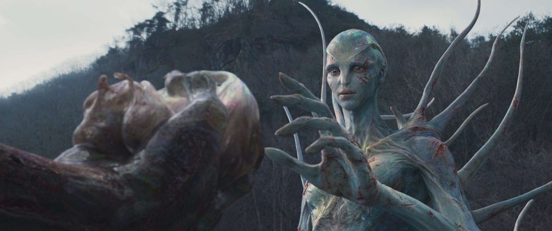 Hope still of an alien being presented a heart.
