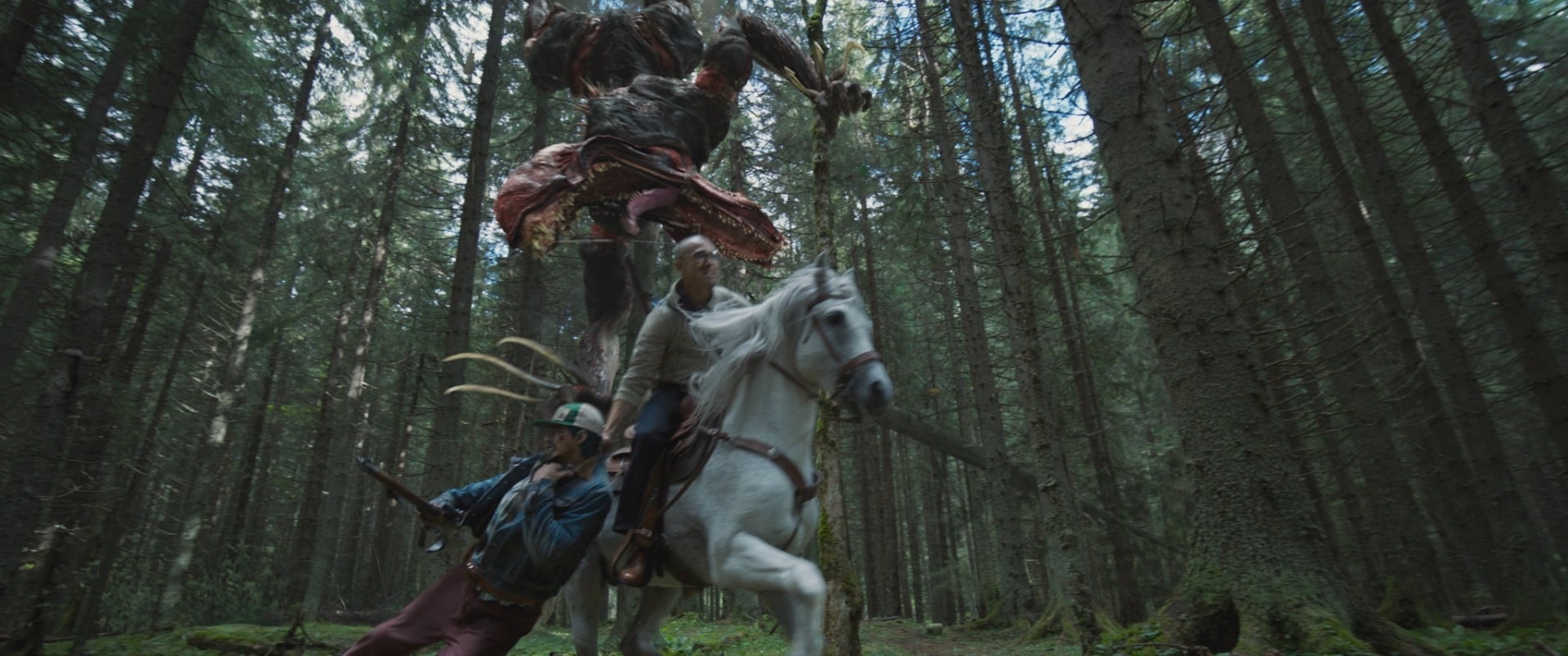 Hope still of aliens hunting humans on horsback in a forest.