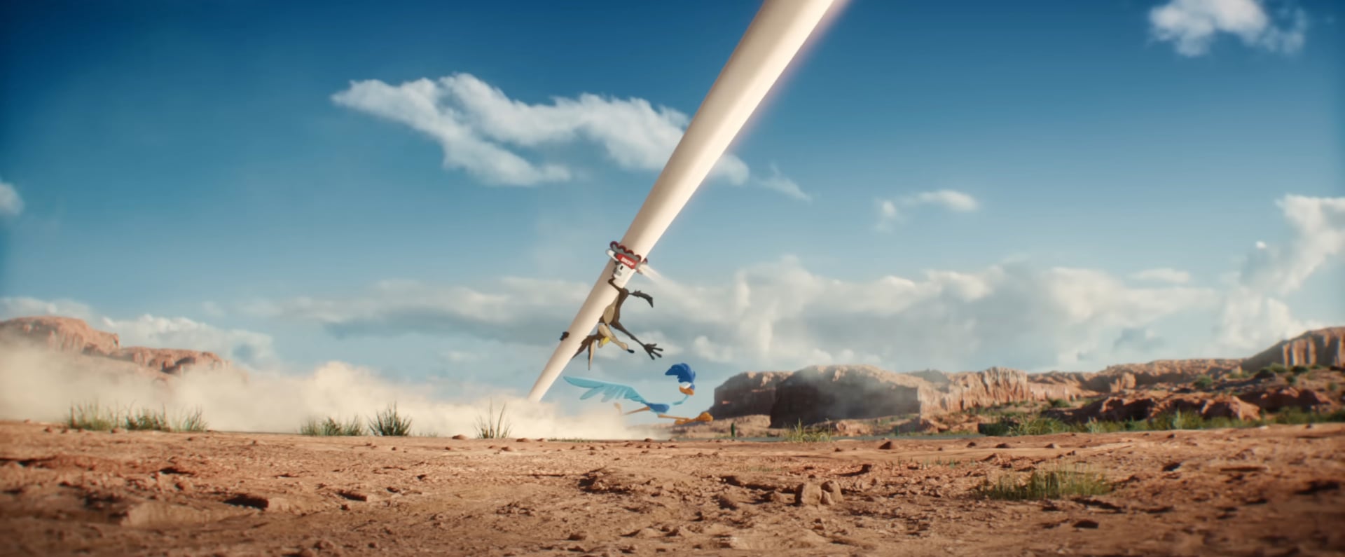 Coyote Vs Acme still of Wile E. Coyote chasing Road Runner.